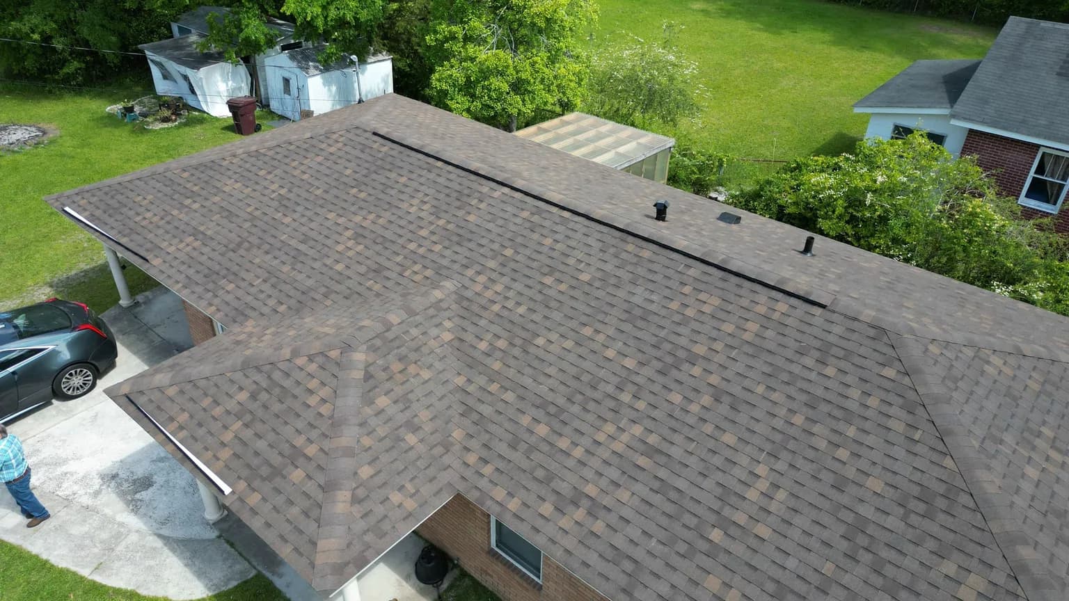 Aerial view of an aging asphalt shingle roof on a brick ranch home in Garden City GA