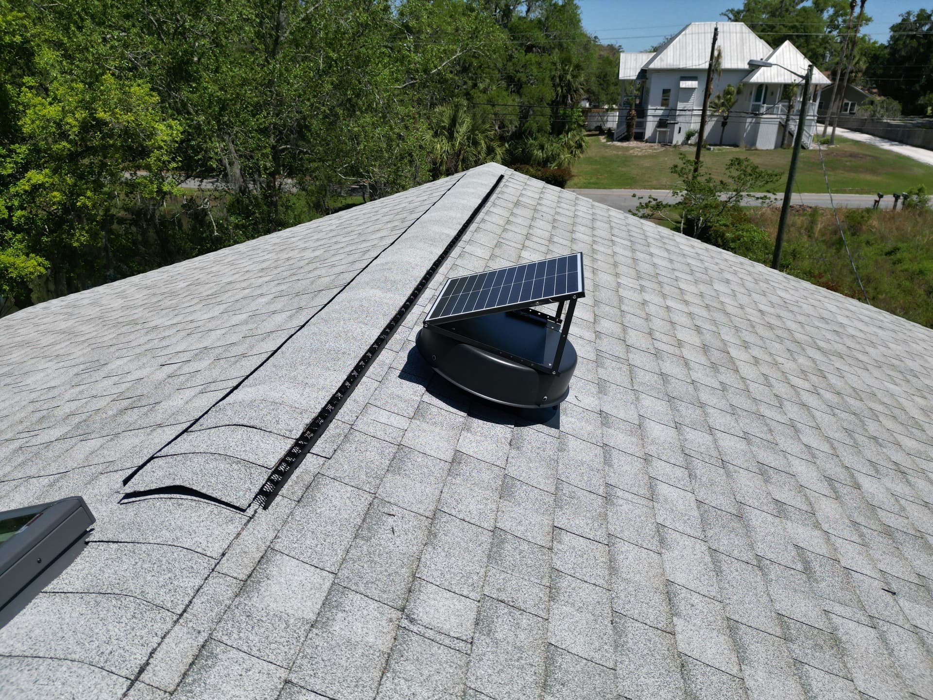 Solar-powered ridge vent installation on new Atlas roof