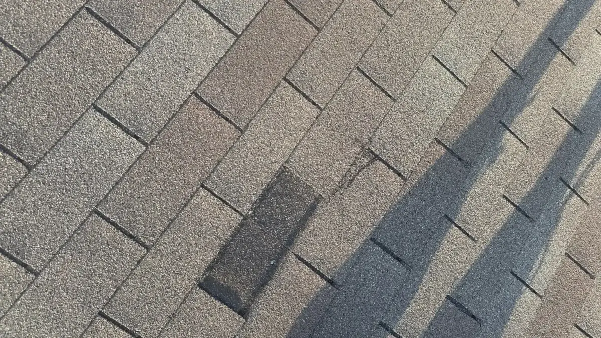 Close view of displaced shingle tabs that should be documented during a Richmond Hill roof inspection